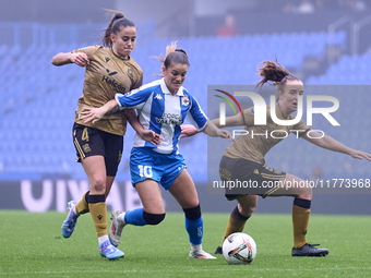 Nahia Aparicio and Ane Etxezarreta of Real Sociedad compete for the ball with Millene Cabral of RC Deportivo Abanca during the Liga F match...