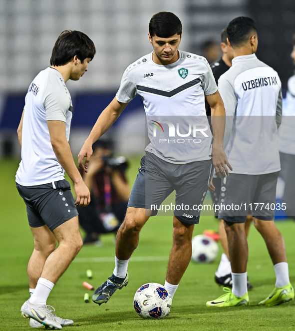 Hojimat Erkinov (L) and Abdukodir Khusanov from the Uzbekistan National football team attend a training session at Jassim Bin Hamad Stadium...