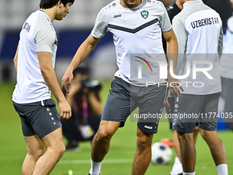 Hojimat Erkinov (L) and Abdukodir Khusanov from the Uzbekistan National football team attend a training session at Jassim Bin Hamad Stadium...