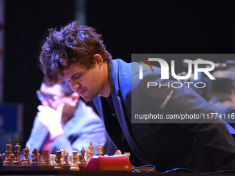 Chess player Magnus Carlsen from Norway, a five-time World Chess Champion, competes against Rameshbabu Praggnanandhaa on the first day of th...