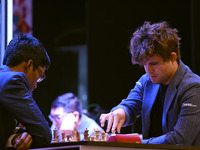 Chess players Rameshbabu Praggnanandhaa of India and Magnus Carlsen of Norway, a five-time World Chess Champion, compete on the first day of...