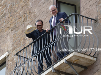 Antonello Venditti and Roberto Gualtieri look out from the balcony of the Campidoglio in Rome, Italy, on November 13, 2024. (