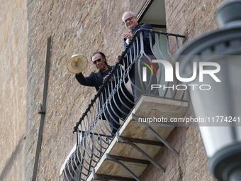 Antonello Venditti and Roberto Gualtieri look out from the balcony of the Campidoglio in Rome, Italy, on November 13, 2024. (