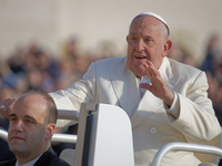 Pope Francis greets the crowd as he arrives for his weekly General Audience in Saint Peter's Square, Vatican City, on November 13, 2024. (