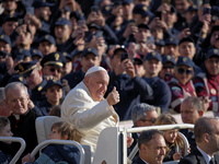 Pope Francis greets the crowd as he arrives for his weekly General Audience in Saint Peter's Square, Vatican City, on November 13, 2024. (