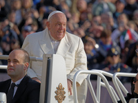 Pope Francis greets the crowd as he arrives for his weekly General Audience in Saint Peter's Square, Vatican City, on November 13, 2024. (