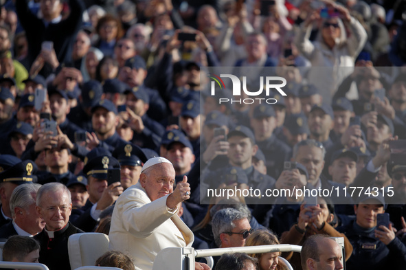 Pope Francis gives a thumbs-up gesture to the faithful and pilgrims during his Wednesday General Audience at St. Peter's Square in Vatican C...