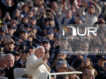 Pope Francis gives a thumbs-up gesture to the faithful and pilgrims during his Wednesday General Audience at St. Peter's Square in Vatican C...