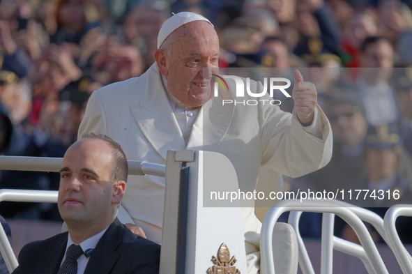 Pope Francis gives a thumbs-up gesture to the faithful and pilgrims during his Wednesday General Audience at St. Peter's Square in Vatican C...