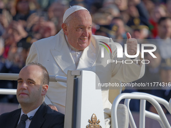 Pope Francis gives a thumbs-up gesture to the faithful and pilgrims during his Wednesday General Audience at St. Peter's Square in Vatican C...