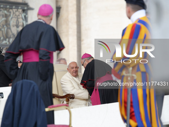 Pope Francis talks with a Cardinal at the end of his weekly General Audience at St. Peter's Square in Vatican City, on November 13, 2024. (