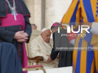 Pope Francis talks with a Cardinal at the end of his weekly General Audience at St. Peter's Square in Vatican City, on November 13, 2024. (