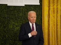 U.S. President Joe Biden listens to first lady Jill Biden speak during the Classroom to Career Summit in the East Room of the White House on...