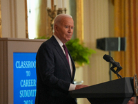 U.S. President Joe Biden listens to first lady Jill Biden speak during the Classroom to Career Summit in the East Room of the White House on...