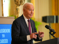 U.S. President Joe Biden listens to first lady Jill Biden speak during the Classroom to Career Summit in the East Room of the White House on...