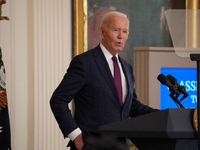 U.S. President Joe Biden listens to first lady Jill Biden speak during the Classroom to Career Summit in the East Room of the White House on...