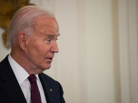 U.S. President Joe Biden listens to first lady Jill Biden speak during the Classroom to Career Summit in the East Room of the White House on...