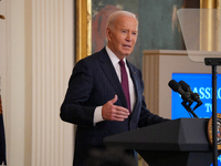 U.S. President Joe Biden listens to first lady Jill Biden speak during the Classroom to Career Summit in the East Room of the White House on...