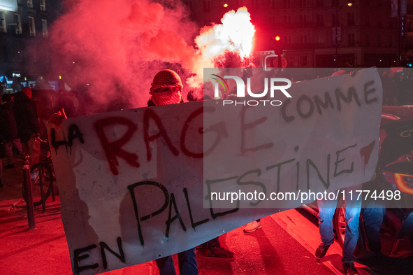 Protesters hold a banner that reads ''the rage as in Palestine'' on an Amsterdam street during a rally organized by political parties (La Fr...