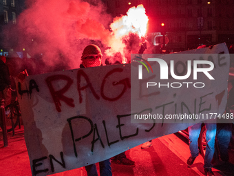 Protesters hold a banner that reads ''the rage as in Palestine'' on an Amsterdam street during a rally organized by political parties (La Fr...