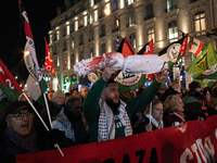 A protester holds a mock-up of a child's body wrapped in a fake blood-stained shroud during a rally organized by political parties (La Franc...