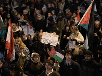 Protesters hold placards and wave Palestinian flags during a rally organized by political parties (La France Insoumise - LFI, Les Ecologiste...