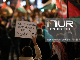 A protester holds a placard reading ''this is not a war, this is a genocide'' during a rally organized by political parties (La France Insou...