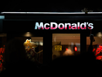 Protesters vandalize the windows of a McDonald's restaurant during a rally organized by political parties (La France Insoumise - LFI, Les Ec...