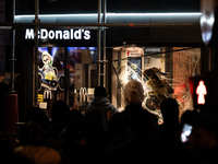 Protesters vandalize the windows of a McDonald's restaurant during a rally organized by political parties (La France Insoumise - LFI, Les Ec...