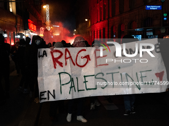 Protesters hold a banner that reads ''the rage as in Palestine'' on an Amsterdam street during a rally organized by political parties (La Fr...