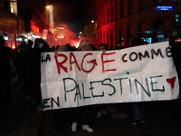 Protesters hold a banner that reads ''the rage as in Palestine'' on an Amsterdam street during a rally organized by political parties (La Fr...