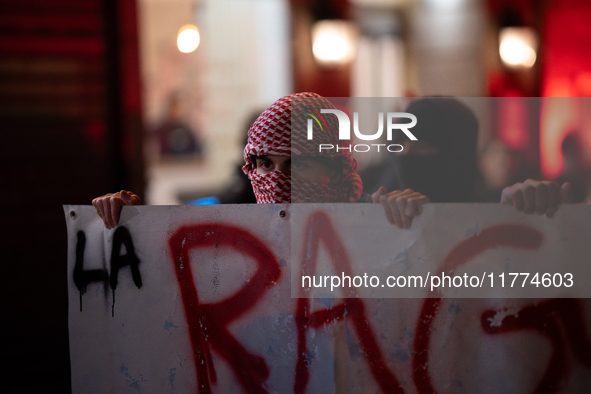 Protesters hold a banner that reads ''the rage as in Palestine'' on an Amsterdam street during a rally organized by political parties (La Fr...