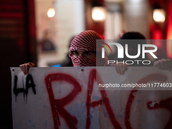 Protesters hold a banner that reads ''the rage as in Palestine'' on an Amsterdam street during a rally organized by political parties (La Fr...