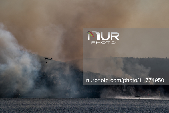 Army National Guard Blackhawk helicopters use water from Greenwood Lake to fight the Jennings Creek Wildfire in Greenwood Lake, NY, U.S., on...