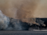 Army National Guard Blackhawk helicopters use water from Greenwood Lake to fight the Jennings Creek Wildfire in Greenwood Lake, NY, U.S., on...