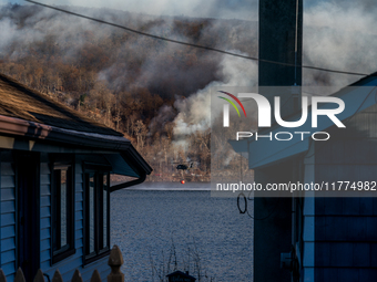 Army National Guard Blackhawk helicopters use water from Greenwood Lake to fight the Jennings Creek Wildfire in Greenwood Lake, NY, U.S., on...