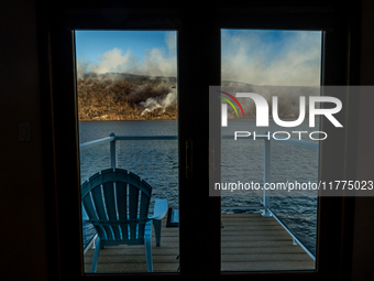 The Jennings Creek Wildfire is seen from a home in Greenwood Lake, NY, U.S., on November 13, 2024. The fire burns roughly 5000 acres with fi...