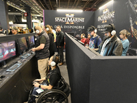 Visitors and gamers play the game ''Warhammer 40,000: Space Marine,'' developed by Relic Entertainment and published by THQ, at the ''Paris...