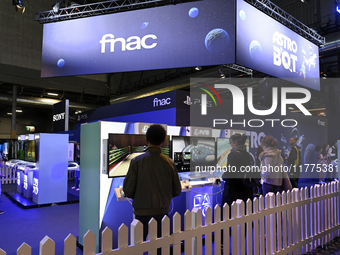 Visitors and gamers play the game ''Astro Bot,'' developed by Team Asobi and published by SONY, at the ''Paris Games Week'' video-game fair...