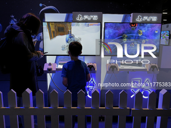 A young gamer plays the game ''Astro Bot'' on PS5 at the ''Paris Games Week'' video-game fair in Paris, France, on October 22, 2024. (