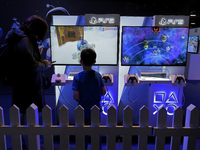 A young gamer plays the game ''Astro Bot'' on PS5 at the ''Paris Games Week'' video-game fair in Paris, France, on October 22, 2024. (