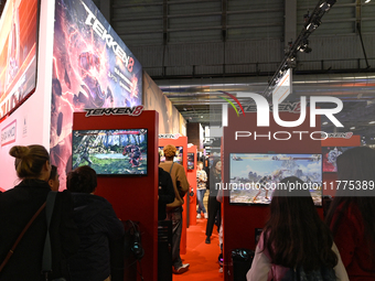 Visitors and gamers play the game ''Tekken 8'' at the Bandai Namco stand during the ''Paris Games Week'' video-game fair in Paris, France, o...