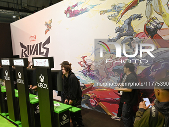 Visitors and gamers play the game ''RIVALS'' at the MARVEL stand during the ''Paris Games Week'' video-game fair in Paris, France, on Octobe...