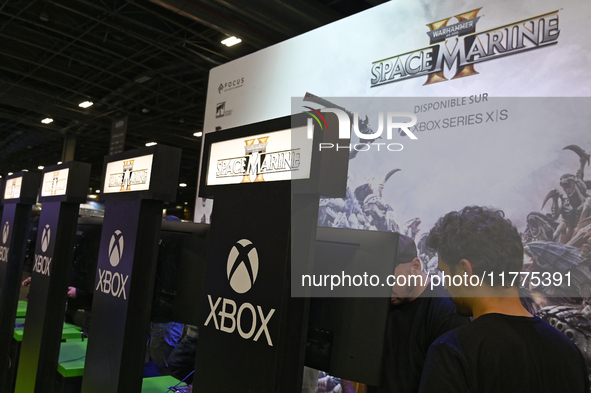 Visitors and gamers play the game ''Warhammer 40,000: Space Marine,'' developed by Relic Entertainment and published by THQ, at the ''Paris...