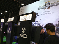 Visitors and gamers play the game ''Warhammer 40,000: Space Marine,'' developed by Relic Entertainment and published by THQ, at the ''Paris...