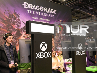 Visitors and gamers play the game ''Dragon Age The Veilguard'' at the ''Paris Games Week'' video-game fair in Paris, France, on October 22,...