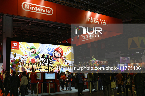 Visitors and gamers play the game ''SUPER MARIO'' at the Nintendo stand during the ''Paris Games Week'' video-game fair in Paris, France, on...