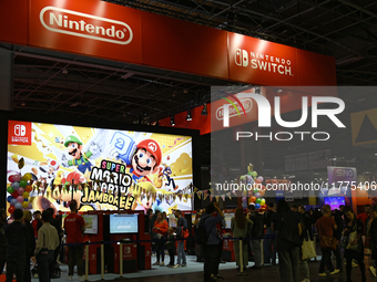 Visitors and gamers play the game ''SUPER MARIO'' at the Nintendo stand during the ''Paris Games Week'' video-game fair in Paris, France, on...