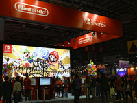 Visitors and gamers play the game ''SUPER MARIO'' at the Nintendo stand during the ''Paris Games Week'' video-game fair in Paris, France, on...