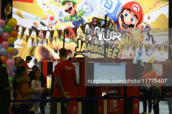 Visitors and gamers play the game ''SUPER MARIO'' at the Nintendo stand during the ''Paris Games Week'' video-game fair in Paris, France, on...